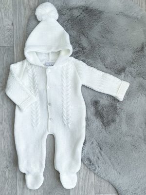 Baby's white knitted pramsuit on a grey fur rug