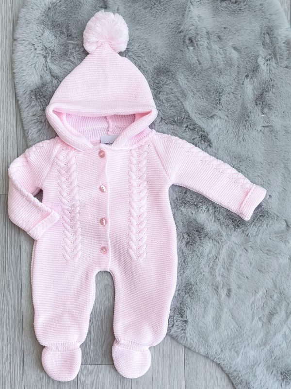 pink knitted pramsuit on a grey fur rug